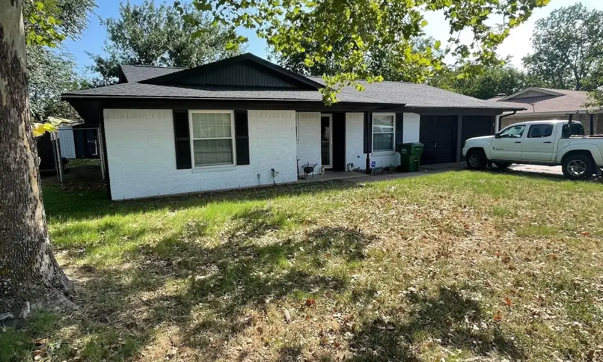 Professional roofing crew working on a residential roof in West Deer
